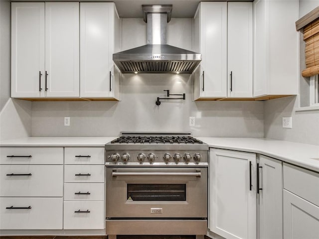 320 N Jasper Way, Mustang, OK 73064 - kitchen with high end stove, wall chimney exhaust hood, white cabinetry, and light countertops