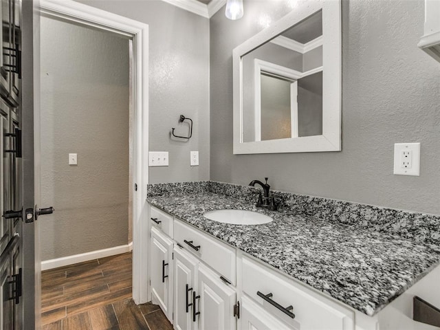 320 N Jasper Way, Mustang, OK 73064 - bathroom featuring crown molding, vanity, wood finished floors, and a textured wall
