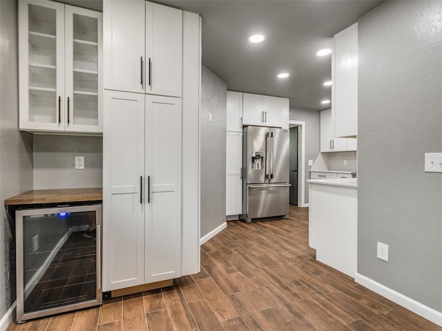 320 N Jasper Way, Mustang, OK 73064 - kitchen with high end fridge, wine cooler, dark wood-style flooring, glass insert cabinets, and white cabinetry