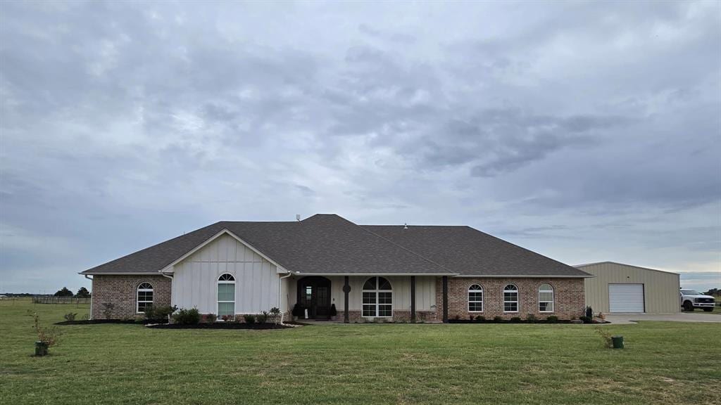 20926 E County Road 156, Altus, OK 73521 - ranch-style house featuring a front yard, an outbuilding, brick siding, and a porch