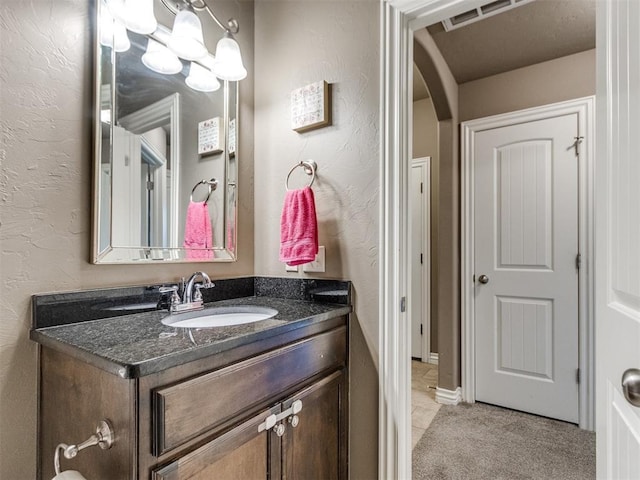8025 Waters Edge Way, Del City, OK 73135 - bathroom with vanity, a textured wall, and tile patterned flooring
