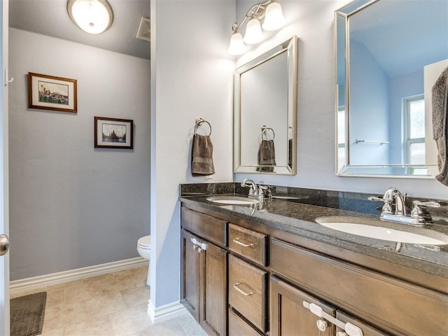 8025 Waters Edge Way, Del City, OK 73135 - bathroom with double vanity and toilet