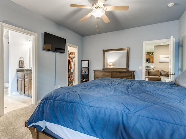 8025 Waters Edge Way, Del City, OK 73135 - carpeted bedroom with a walk in closet, ensuite bath, a closet, and ceiling fan