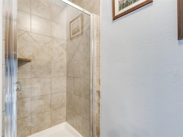 8025 Waters Edge Way, Del City, OK 73135 - full bathroom featuring a stall shower and a textured wall