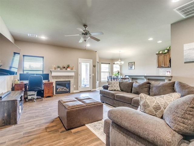 8025 Waters Edge Way, Del City, OK 73135 - living room featuring light wood-type flooring, ceiling fan, recessed lighting, a chandelier, and a fireplace