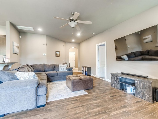 8025 Waters Edge Way, Del City, OK 73135 - living area featuring arched walkways, wood finished floors, a ceiling fan, and recessed lighting
