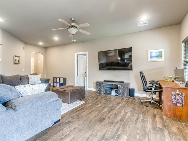 8025 Waters Edge Way, Del City, OK 73135 - living area with arched walkways, a ceiling fan, a desk, recessed lighting, and wood finished floors