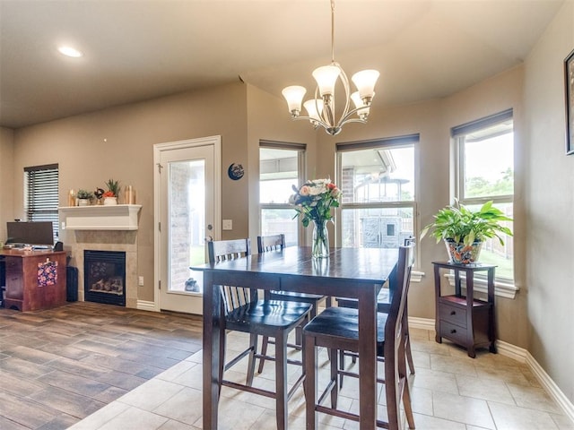 8025 Waters Edge Way, Del City, OK 73135 - dining room featuring a chandelier, a tile fireplace, light tile patterned floors, and recessed lighting