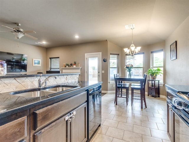8025 Waters Edge Way, Del City, OK 73135 - kitchen with dishwasher, a chandelier, black stove, hanging light fixtures, and recessed lighting