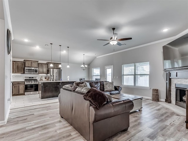 11604 SW 9th St, Yukon, OK 73099 - living room with lofted ceiling, a ceiling fan, light wood-style floors, a brick fireplace, and crown molding