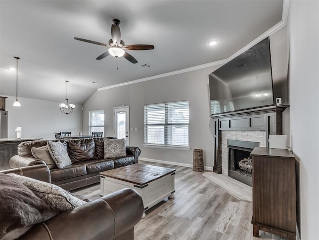 11604 SW 9th St, Yukon, OK 73099 - living room featuring a ceiling fan, crown molding, a fireplace, a chandelier, and vaulted ceiling