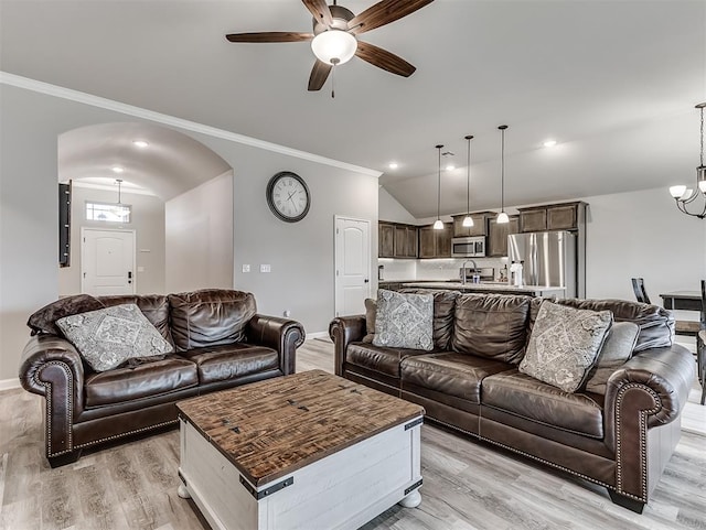 11604 SW 9th St, Yukon, OK 73099 - living room with a ceiling fan, ornamental molding, vaulted ceiling, light wood-style floors, and arched walkways