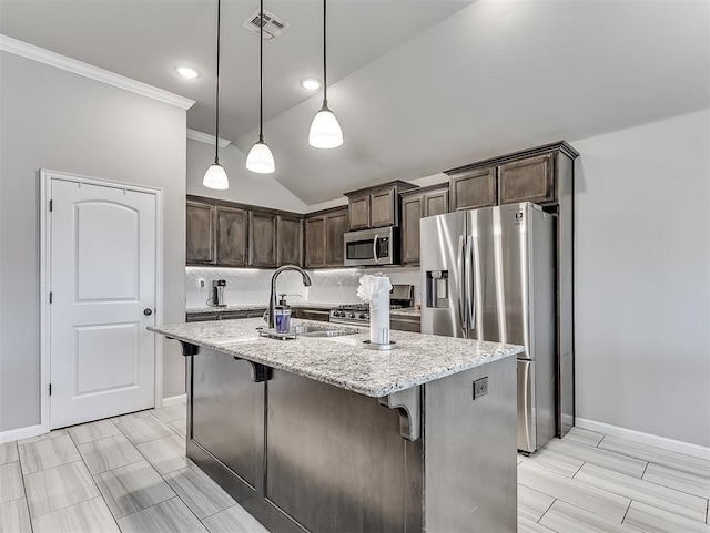 11604 SW 9th St, Yukon, OK 73099 - kitchen with stainless steel appliances, dark brown cabinetry, light stone counters, pendant lighting, and a kitchen bar