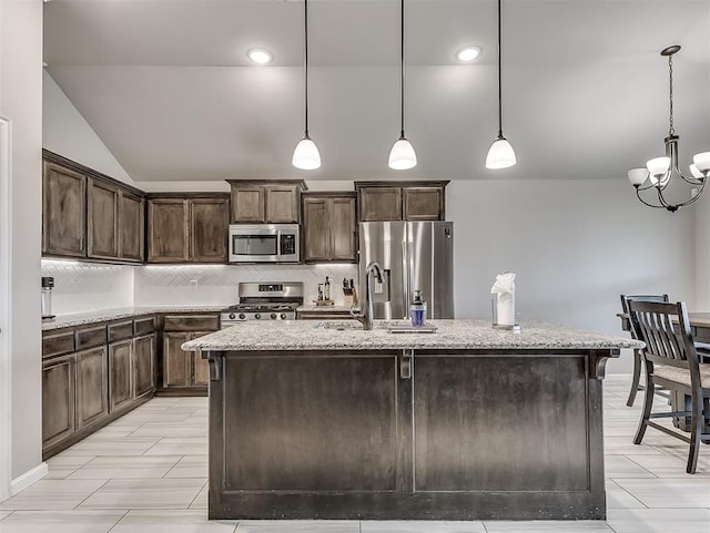 11604 SW 9th St, Yukon, OK 73099 - kitchen with stainless steel appliances, dark brown cabinets, backsplash, vaulted ceiling, and light stone counters