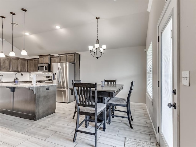 11604 SW 9th St, Yukon, OK 73099 - dining room featuring vaulted ceiling and a chandelier