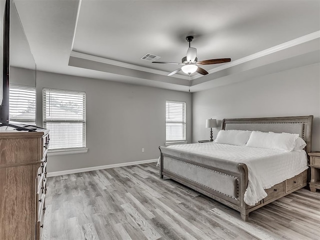 11604 SW 9th St, Yukon, OK 73099 - bedroom with a tray ceiling, crown molding, light wood-type flooring, and a ceiling fan