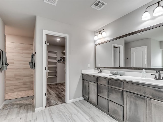 11604 SW 9th St, Yukon, OK 73099 - full bathroom with double vanity, a walk in closet, and a tile shower