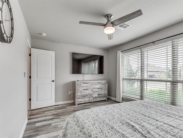 11604 SW 9th St, Yukon, OK 73099 - bedroom featuring wood finished floors and a ceiling fan