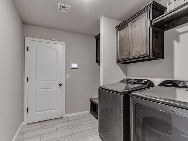 11604 SW 9th St, Yukon, OK 73099 - laundry area featuring separate washer and dryer and cabinet space