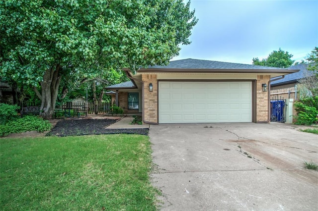 7913 Debar Cir, Oklahoma City, OK 73132 - view of front of property featuring concrete driveway, brick siding, and an attached garage