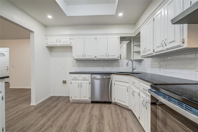 7913 Debar Cir, Oklahoma City, OK 73132 - kitchen with appliances with stainless steel finishes, white cabinets, light wood-style flooring, tasteful backsplash, and recessed lighting