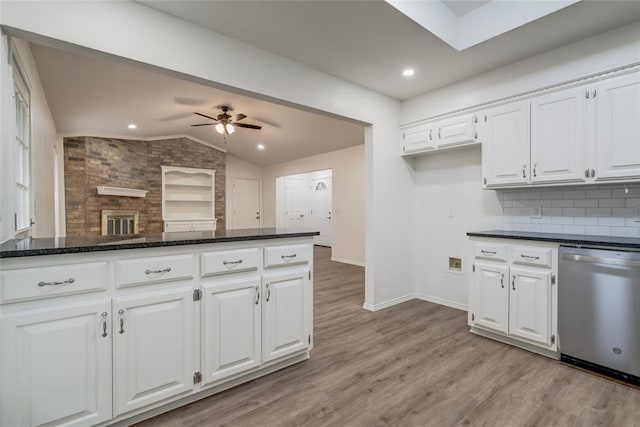 7913 Debar Cir, Oklahoma City, OK 73132 - kitchen with stainless steel dishwasher, vaulted ceiling, a ceiling fan, white cabinetry, and light wood-style flooring