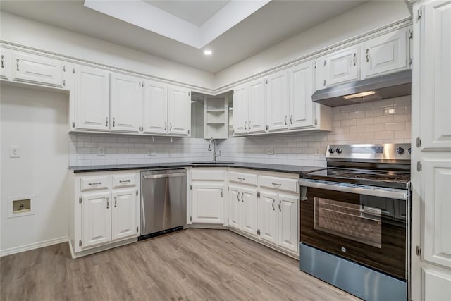 7913 Debar Cir, Oklahoma City, OK 73132 - kitchen with stainless steel appliances, under cabinet range hood, dark countertops, white cabinets, and recessed lighting