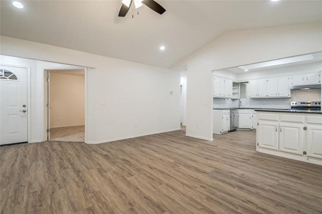 7913 Debar Cir, Oklahoma City, OK 73132 - unfurnished living room with ceiling fan, vaulted ceiling, light wood-style floors, and recessed lighting