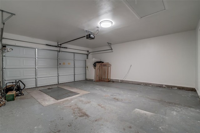 7913 Debar Cir, Oklahoma City, OK 73132 - garage featuring a garage door opener and baseboards