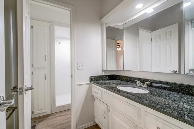 7913 Debar Cir, Oklahoma City, OK 73132 - bathroom featuring vanity, a stall shower, and wood finished floors