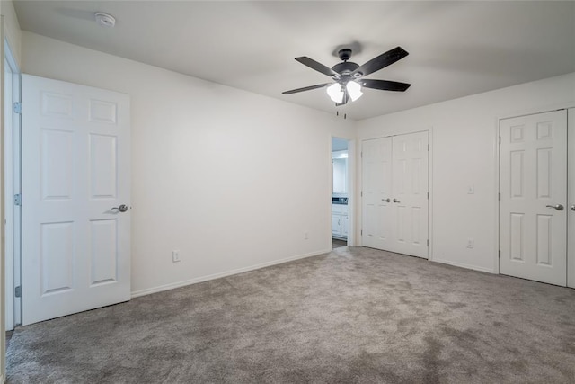 7913 Debar Cir, Oklahoma City, OK 73132 - unfurnished bedroom featuring multiple closets, carpet flooring, and a ceiling fan