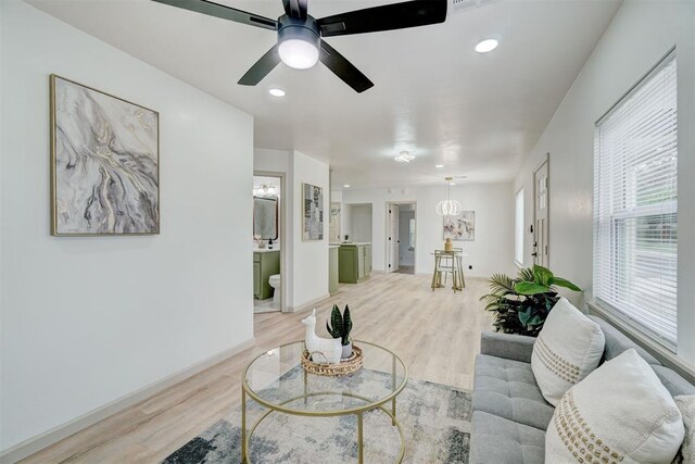 800 SW 26th St, Oklahoma City, OK 73109 - living room featuring light wood finished floors, recessed lighting, a ceiling fan, and a chandelier