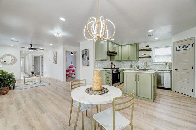 800 SW 26th St, Oklahoma City, OK 73109 - kitchen with green cabinetry, stainless steel appliances, under cabinet range hood, light wood-type flooring, and light countertops