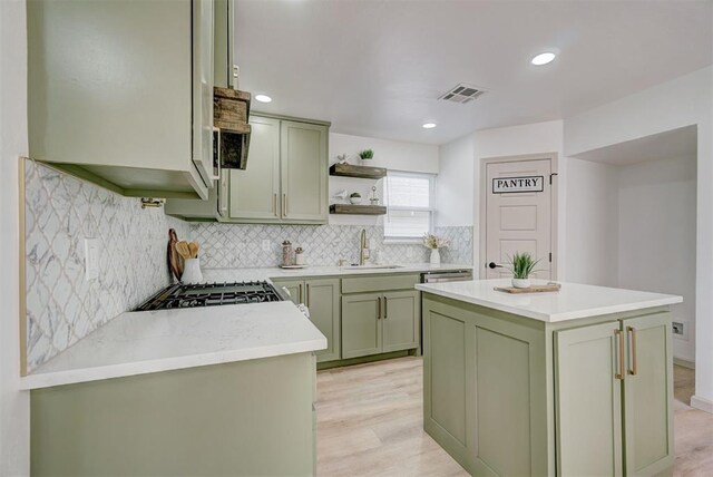 800 SW 26th St, Oklahoma City, OK 73109 - kitchen featuring green cabinets, open shelves, light countertops, decorative backsplash, and light wood-style floors