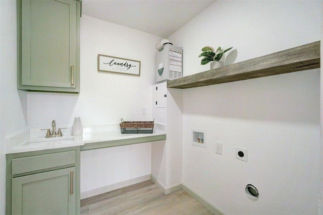 800 SW 26th St, Oklahoma City, OK 73109 - washroom with electric dryer hookup, hookup for a washing machine, cabinet space, and light wood-style flooring