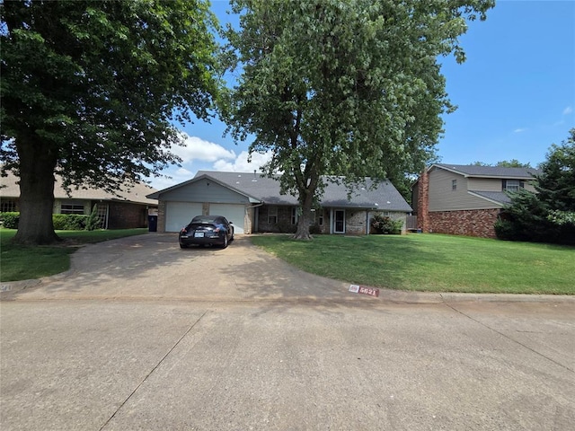 5621 NW 83rd St, Oklahoma City, OK 73132 - ranch-style house featuring a front lawn, concrete driveway, an attached garage, and brick siding