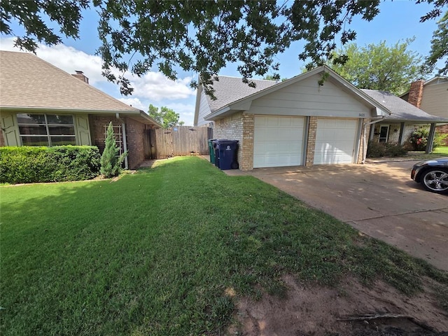 5621 NW 83rd St, Oklahoma City, OK 73132 - view of side of home with brick siding, driveway, and an attached garage