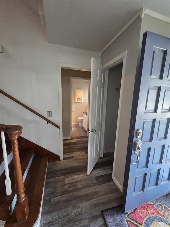 5621 NW 83rd St, Oklahoma City, OK 73132 - entryway with dark wood-type flooring, ornamental molding, and stairway