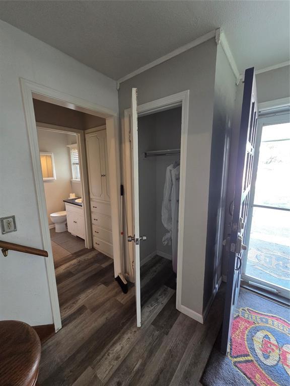 5621 NW 83rd St, Oklahoma City, OK 73132 - interior space with dark wood-type flooring, multiple windows, ornamental molding, and ensuite bath