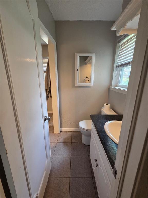 5621 NW 83rd St, Oklahoma City, OK 73132 - half bath with vanity, tile patterned flooring, and a textured ceiling