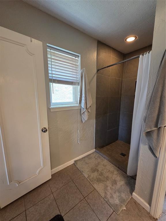 5621 NW 83rd St, Oklahoma City, OK 73132 - bathroom with a textured ceiling, a tile shower, tile patterned flooring, and recessed lighting