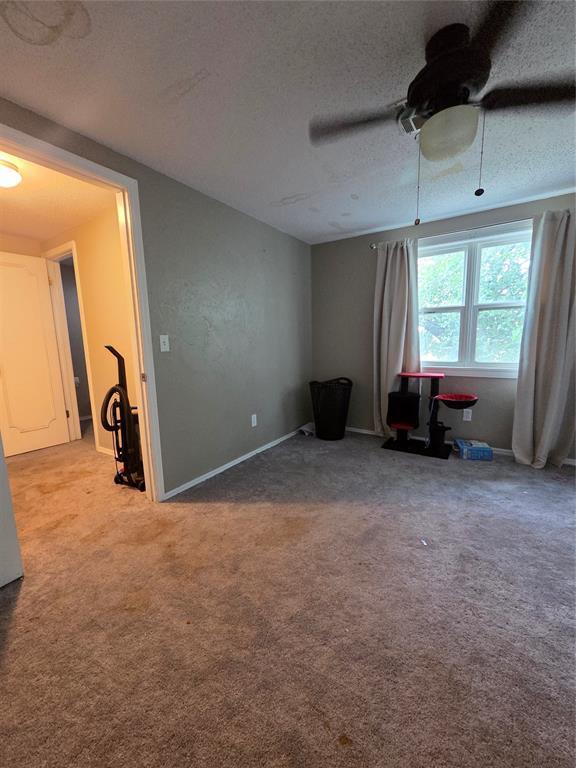 5621 NW 83rd St, Oklahoma City, OK 73132 - unfurnished room with carpet flooring, a textured ceiling, and a ceiling fan