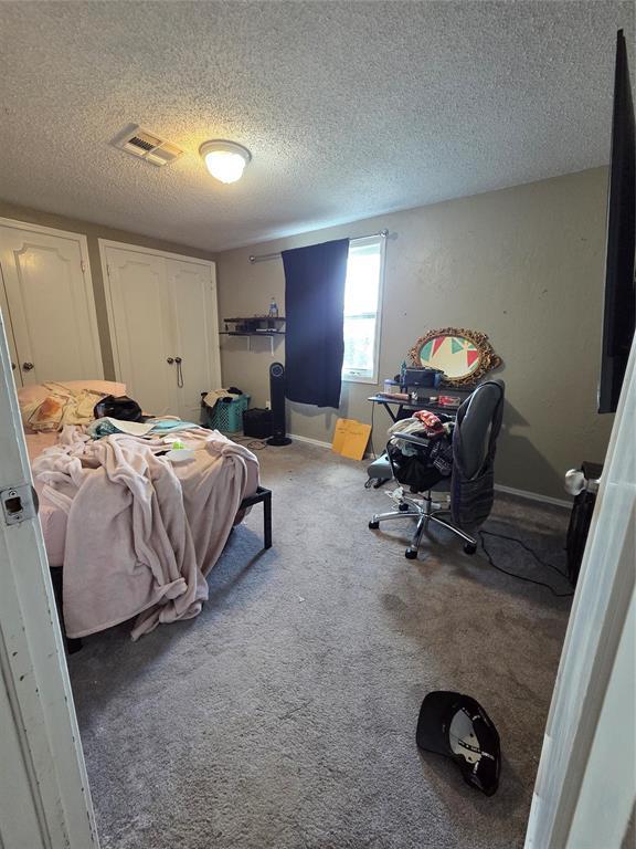 5621 NW 83rd St, Oklahoma City, OK 73132 - carpeted bedroom with a textured ceiling