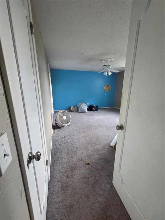 5621 NW 83rd St, Oklahoma City, OK 73132 - spare room with carpet flooring, a textured ceiling, and a ceiling fan