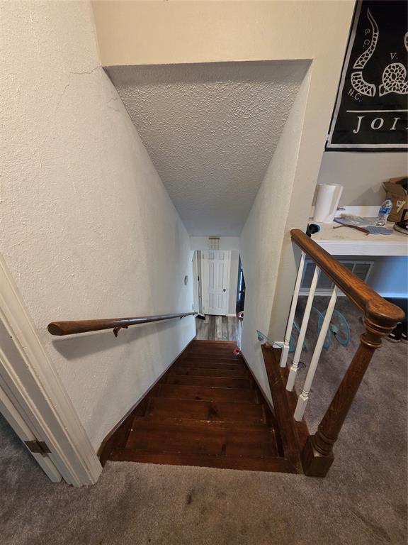5621 NW 83rd St, Oklahoma City, OK 73132 - stairs with a textured ceiling and carpet