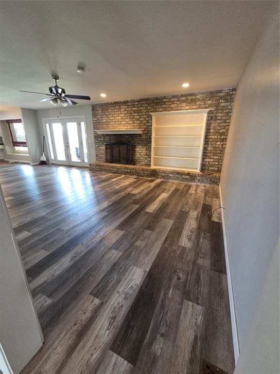 5621 NW 83rd St, Oklahoma City, OK 73132 - unfurnished living room featuring a fireplace, wood finished floors, a ceiling fan, and recessed lighting