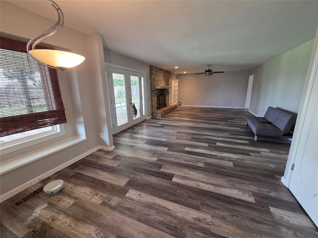 5621 NW 83rd St, Oklahoma City, OK 73132 - unfurnished living room featuring ceiling fan, dark wood finished floors, a brick fireplace, french doors, and recessed lighting