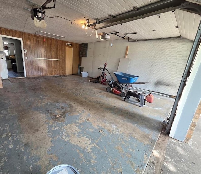5621 NW 83rd St, Oklahoma City, OK 73132 - garage with wood walls and a garage door opener