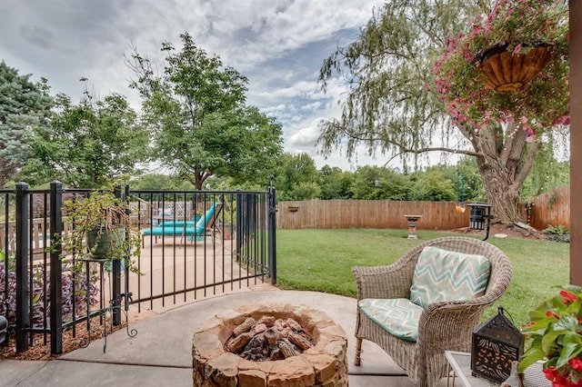 16204 Old Olive Way, Edmond, OK 73013 - fenced backyard with a fire pit, a patio area, and a gate