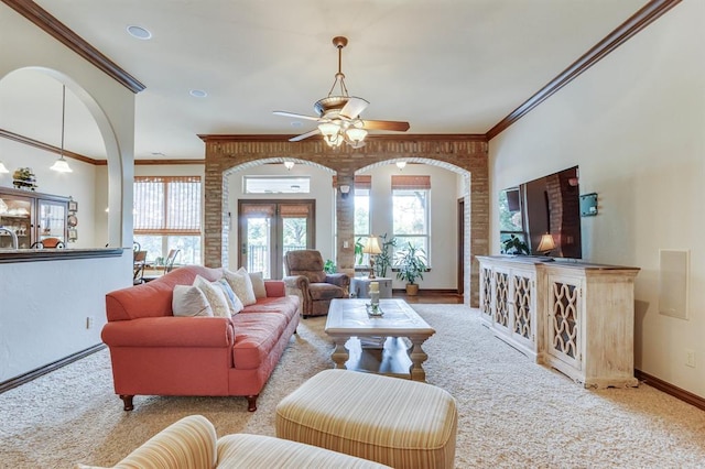 16204 Old Olive Way, Edmond, OK 73013 - living room with carpet floors, ornamental molding, ceiling fan, and healthy amount of natural light